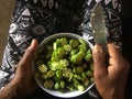 Woman hands slicing Okra