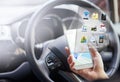 Woman, hands and smartphone with hologram in car with digital maps for smart driving and assist with navigation. Person
