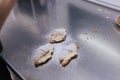 Woman hands sprinkling white flour over croissants on bakery Royalty Free Stock Photo