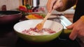 Woman hands sweat or saute onions in frying pan - slow motion