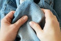 Woman hands takes jeans jackets with pockets, denim fashion