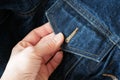 Woman hands takes jeans jackets with pockets, denim fashion