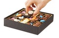 Woman hands taking chocolate in box Royalty Free Stock Photo