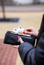 Woman hands taking money out of black leather purse Royalty Free Stock Photo