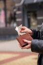 Woman hands taking money out of brown leather wallet Royalty Free Stock Photo