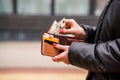 Woman hands taking money out of brown leather wallet Royalty Free Stock Photo