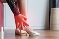 Woman hands taking off high heel shoes because suffering from feet pain Royalty Free Stock Photo