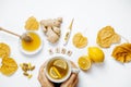 Woman hands with tea, Wooden word sick, lemon, thermometer, ginger, honey, tablets and dry leaves on a white background. flat lay Royalty Free Stock Photo