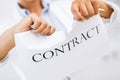 Woman hands tearing contract paper