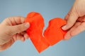 Woman hands tearing red paper heart Royalty Free Stock Photo