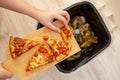 Woman hands throwing food into the trash, bin, waste of food, food concept Royalty Free Stock Photo