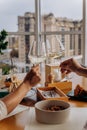 Close up of hands toasting wine glasses at dinner in restaurant. Drinks and celebration concept Royalty Free Stock Photo