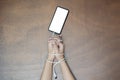 Woman hands trapped and wrapped on wrists with mobile phone cable as handcuffs in smart phone networking Royalty Free Stock Photo