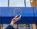 Woman hands trying to hold the stars of European Union insignia