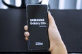 Woman hands turn on a Samsung Galaxy S10+ phone