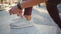 Woman hands tying laces on sneakers outdoor closeup. Runner lacing up footwear