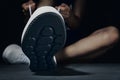 Woman hands tying shoelaces on sneakers on dark background. Fitness athlete ready for exercise Royalty Free Stock Photo