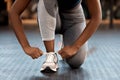 Woman, hands and tying shoes in fitness at gym or running, exercise or cardio workout indoors. Hand of female person Royalty Free Stock Photo