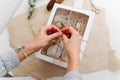 Woman hands tying windowed box with multi-use eco-friendly items