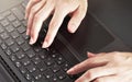 Woman hands typing on black laptop keyboard, close up detail from above Royalty Free Stock Photo