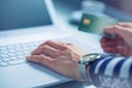 Woman hands typing on the keyboard of laptop holding credit card Royalty Free Stock Photo