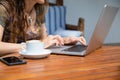 woman hands typing on keyboard pc laptop with coffee cup on table Royalty Free Stock Photo