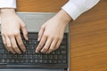 Woman hands typing on laptop keyboard