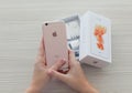 Woman hands unpacking iPhone6S Rose Gold