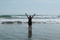 Woman is hands up on sea beach. Raised outstretched arms Royalty Free Stock Photo