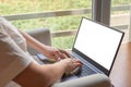 Woman hands using computer mockup laptop with blank white screen at home interior. Woman using a laptop next to window Royalty Free Stock Photo