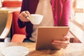 Woman hands using and holding computer tablet in coffee shop Royalty Free Stock Photo