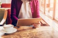 Woman hands using and holding computer tablet in coffee shop Royalty Free Stock Photo