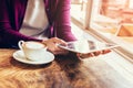 Woman hands using and holding computer tablet in coffee shop Royalty Free Stock Photo