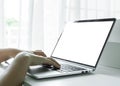 Woman hands using laptop with blank screen on white table at home or office Royalty Free Stock Photo