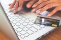 Woman hands using laptop computer with plastic credit card on keyboard. Selective focus . Online shopping, paying, buying Royalty Free Stock Photo