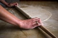 Woman hands using rolling pin in the kitchen to make dough Royalty Free Stock Photo