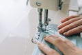 Woman hands using the sewing machine to sew the face home made diy medical mask during the coronavirus pandemia Royalty Free Stock Photo