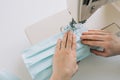 Woman hands using the sewing machine to sew the face home made diy medical mask during the coronavirus pandemia Royalty Free Stock Photo