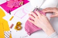 Woman hands using a sewing machine to sew a pink ladies face mask during the coronavirus pandemia Royalty Free Stock Photo