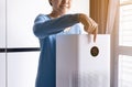 Woman hands using white modern air purifier in a living room for refresh air flow at home,Advanced air purifying and protect Pm2.5