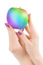 Hands holding rainbow colored apple isolated with clipping path