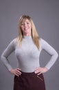 Woman with hands on waist wearing a tight jumper