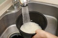 Woman hands washing rice