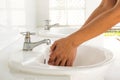 Woman hands washing under clean water pour. In public rest room.