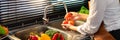 Woman hands washing Vegetables for Preparation of vegan salad on the worktop near to sink in a modern kitchen, Homemade healthy Royalty Free Stock Photo