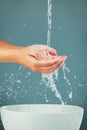 Woman hands, water splash with sink, washing and skin  on studio background, hygiene and skincare with beauty Royalty Free Stock Photo