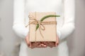 Woman hands with white sweater holding a diy gift box for special event with copy space Royalty Free Stock Photo