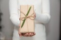 Woman hands with white sweater holding a diy gift box for special event with copy space Royalty Free Stock Photo