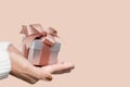 Woman hands with white sweater holding a small gift box for special event with copy space Royalty Free Stock Photo