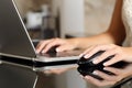 Woman hands working with a laptop and a mouse